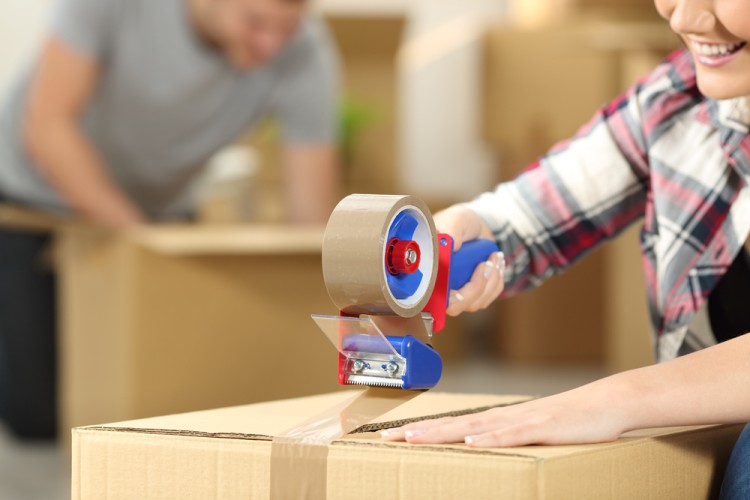 Mover packing items into boxes for relocation.