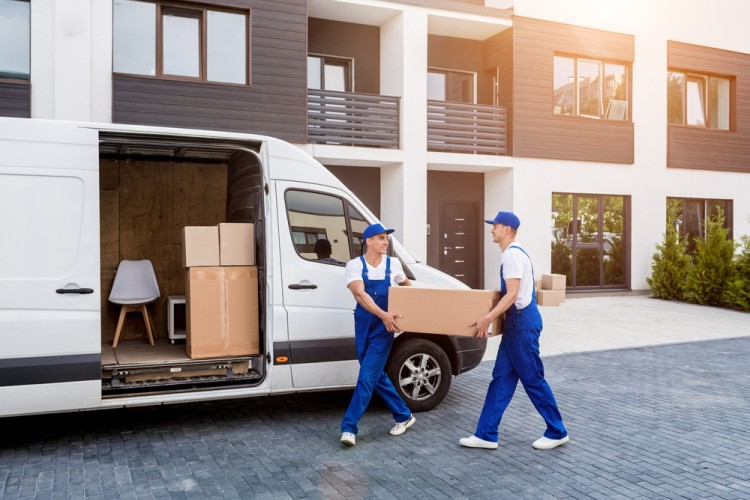 Movers loading boxes into a moving truck.