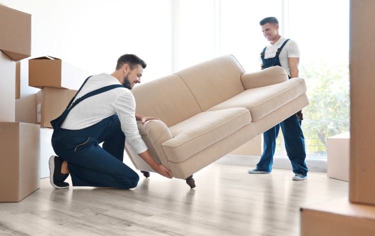 Home removal staff lifting sofa set