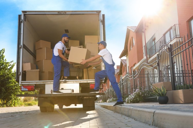 Professional movers loading boxes into truck